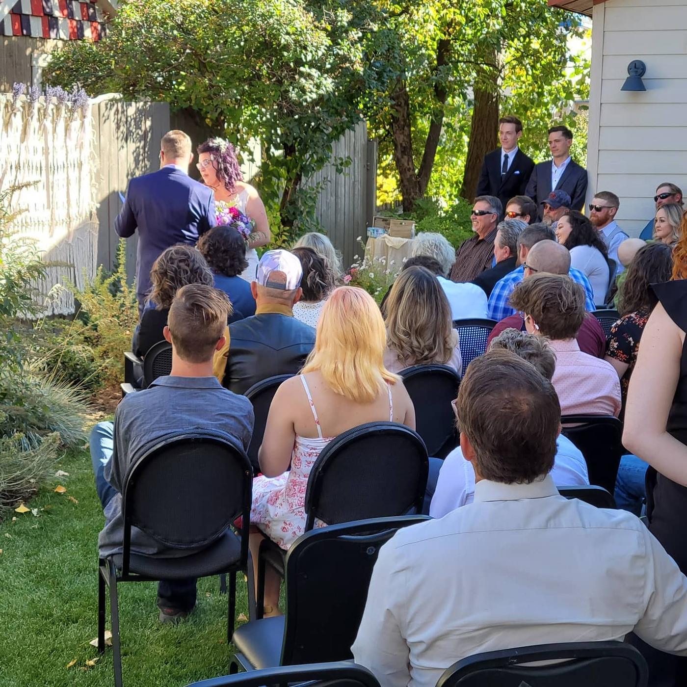 Guests seated for a wedding ceremony in the Mill Street Bistro garden
