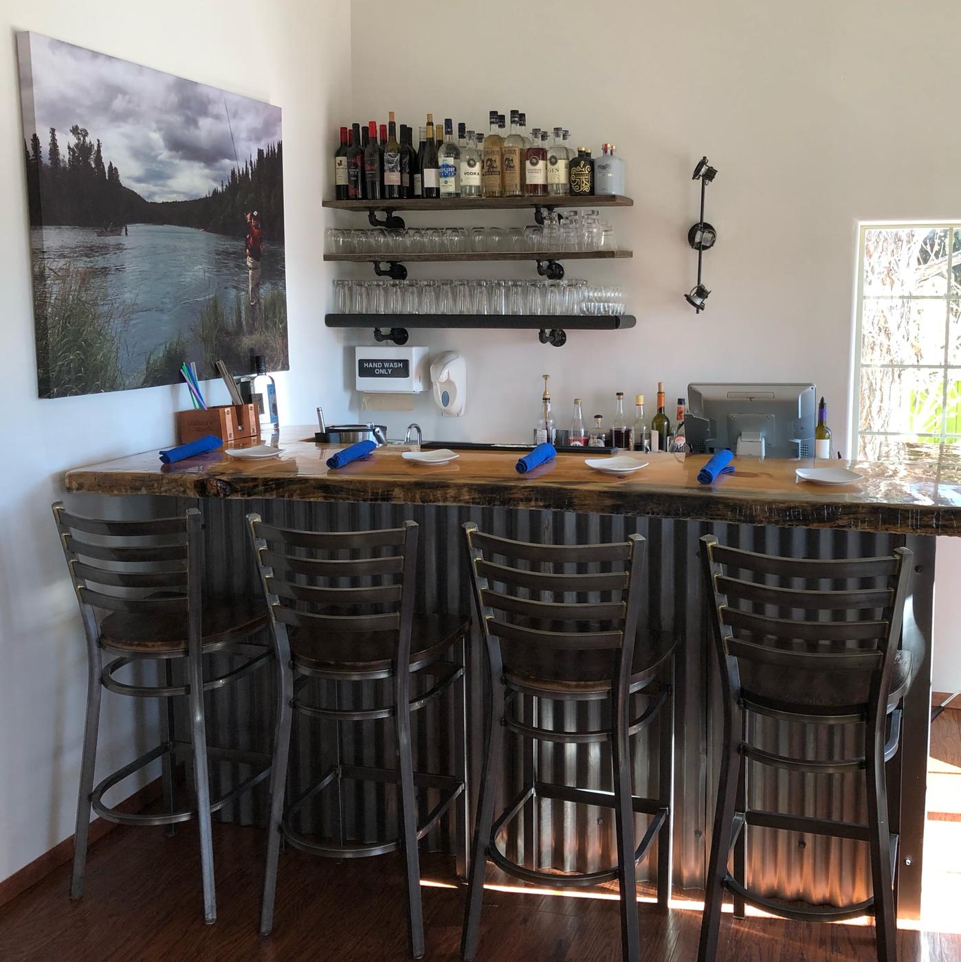 The bar at Mill Street Bistro with stools and shelves of spirits