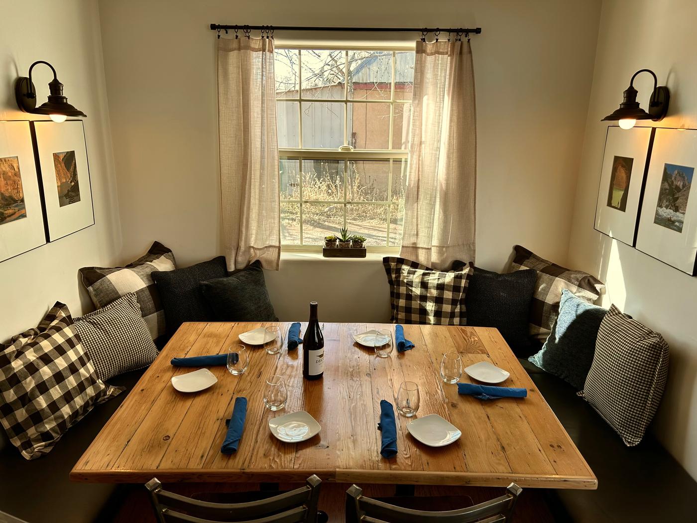 The cozy booth alcove at Mill Street Bistro, set with royal-blue napkins and a bottle of wine