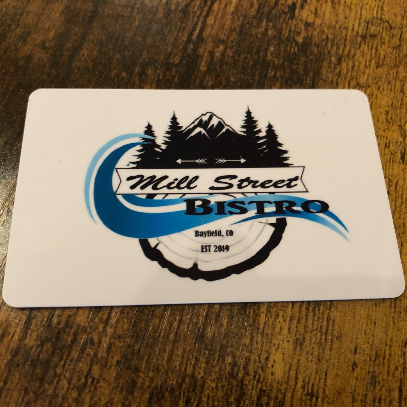 A Mill Street Bistro gift card on a wood table